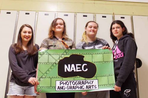Natalie Reynolds, Brittany & Shannon Delyea and Terri-Lynn Rosenblath with the banner they designed for the Bon Echo Art Show. Photo by Summer Andrew.